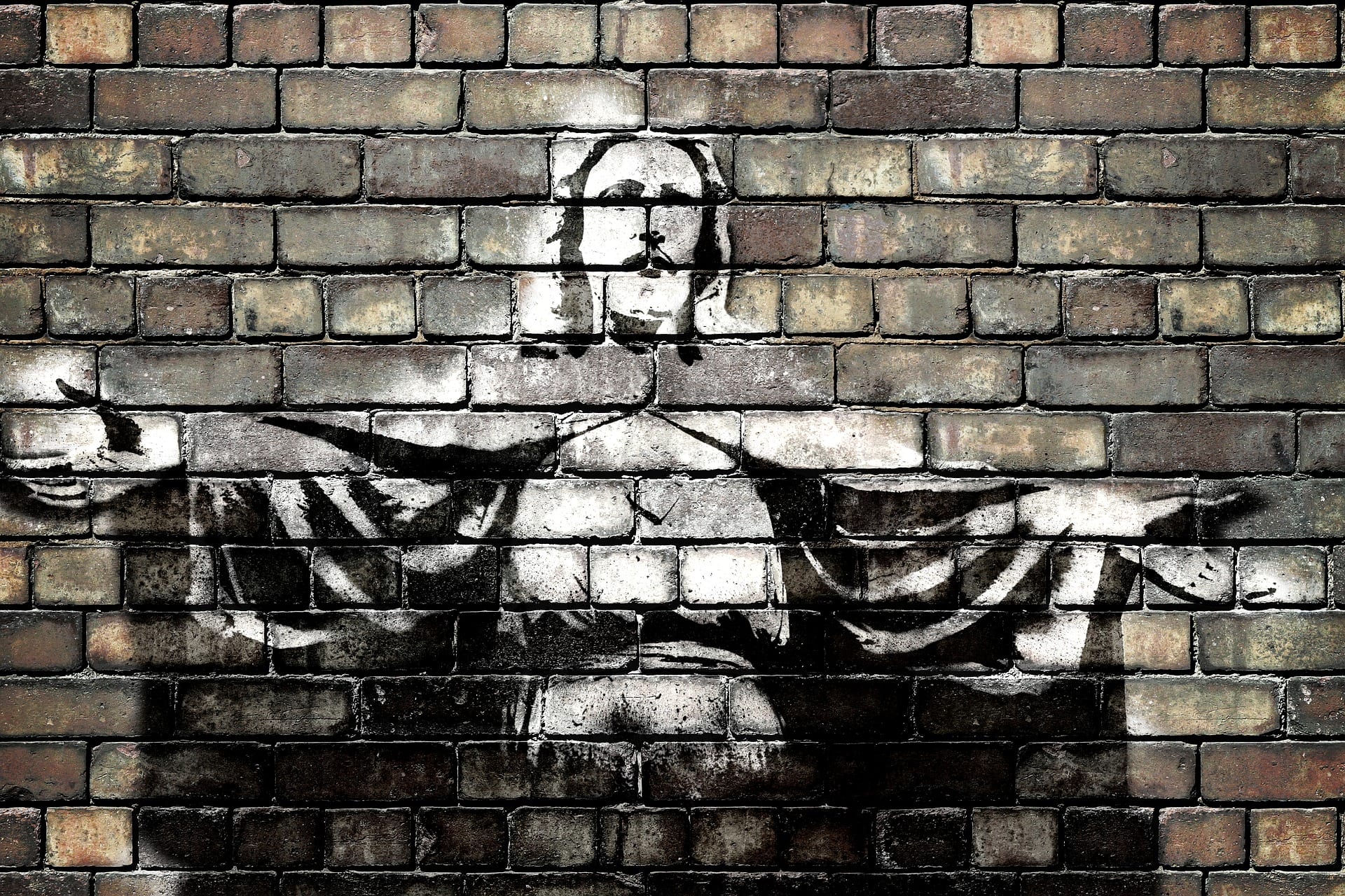 Jesus spray painted on brick wall